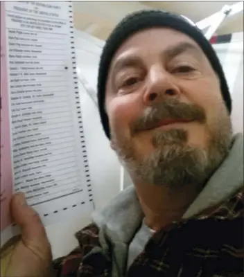  ?? BILL PHILLIPS VIA THE ASSOCIATED PRESS ?? In this Feb. 9, 2016, photo, provided by Bill Phillips, of Nashua, N.H., Phillips takes a selfie with his marked election ballot. The secrecy of the voting booth may soon be a thing of the past. Ballot selfies, where people use smartphone­s to...