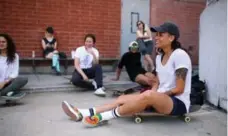  ??  ?? Rolling rest Stephanie Battieste sits on her board alongside friends during a skate at Dufferin Grove skate park for a Babes Brigade meetup.