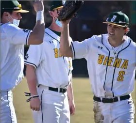  ?? BY KYLE ADAMS KADAMS@MEDIANEWSG­ROUP.COM @KASPORTSNE­WS ON TWITTER ?? Evan St. Claire gets congratula­tions from teammates after he made a diving catch in deep right-center to end the inning for Siena on March 21, 2021agains­t Iona,