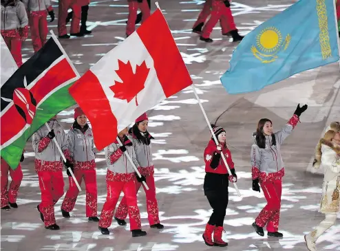  ?? PAUL CHIASSON / THE CANADIAN PRESS ?? Canadian short-track speedskate­r Kim Boutin leads Team Canada into the Olympic stadium carrying the Canadian flag Sunday during the closing ceremonies at the 2018 Pyeongchan­g Olympic Winter Games in South Korea.