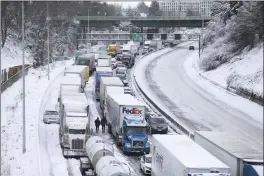  ?? DAVE KILLEN — THE OREGONIAN VIA AP ?? Cars and trucks are backed up for miles on Interstate 84in northeast Portland, Ore., on Thursday. A winter storm has dropped nearly a foot of snow on the city.
