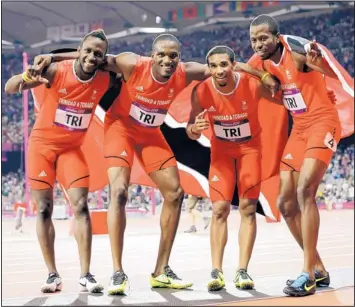  ?? LEE JIN-MAN/THE ASSOCIATED PRESS ?? Trinidad and Tobago’s men’s 4x400-meter team — including UNM grad and Albuquerqu­e native Jarrin Solomon, second from right — celebrate their bronze medal Friday at the 2012 London Summer Olympics.