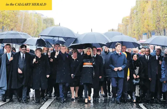  ?? LUDOVIC MARIN / POOL PHOTO VIA AP ?? In Paris Sunday, from left, Morocco’s Prince Moulay Hassan, Moroccan King Mohammed VI, German Chancellor Angela Merkel, French President Emmanuel Macron with wife Brigitte Macron, Prime Minister Justin Trudeau, Niger’s First Lady Lalla Malika Issoufou, President of Niger Mahamadou Issoufou and Republic of Guinea President Alpha Condé.