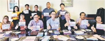  ??  ?? Zhang (seated centre) and Chong (seated third right) during a photo call for the press conference.