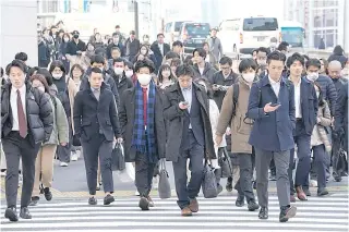  ?? AFP PHOTO ?? DEMOTED
People commuting to work in the morning cross a pedestrian crossing in Tokyo, Japan, on Thursday, Feb. 15, 2024. Japan’s moved down to being the third-largest economy to fourth after being overtaken by Germany last year.