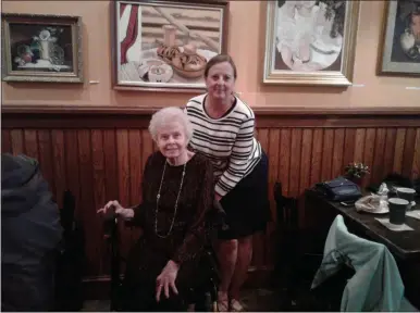  ?? MELISSA SCHUMAN — MEDIA NEWS GROUP ?? Janet Pazak and daughter Sharon Miller pose in front of Pazak’s paintings at Uncommon Grounds.