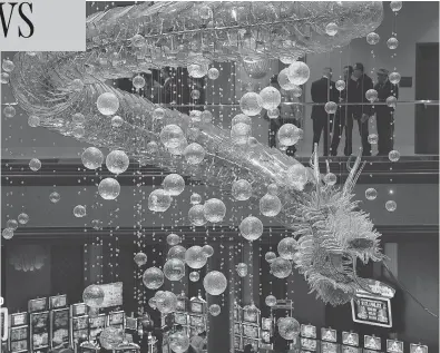  ?? ETHAN MILLER / GETTY IMAGES ?? A 1.25-ton glass dragon chandelier hangs as the centrepiec­e of Lucky Dragon Hotel & Casino in Las Vegas during its grand opening Dec. 3. The resort is designed to give visitors an authentic Asian cultural and gambling experience.