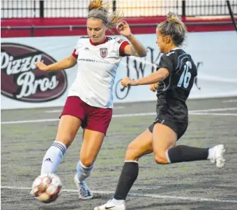  ?? STAFF PHOTO BY PATRICK MACCOON ?? Former Baylor School standout and Chattanoog­a Lady Red Wolves forward Avery Davis defends against a Nashville Rhythm attacker in Sunday’s WPSL Southeast Conference final at David Stanton Field. Chattanoog­a rallied for a 3-2 victory.