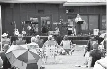  ??  ?? Emily Knauss, teaching pastor, leads a portion of the Sunday morning outdoor service at Discovery Christian Church.