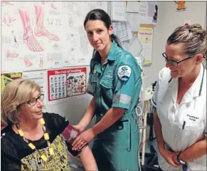  ?? Photo: RHIANNON McCONNELL ?? Health test: Kate Worthingto­n, middle, checks Lyn Turner’s blood pressure as nurse Susan Milligan looks on.