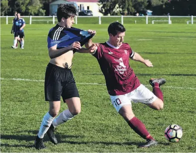  ?? PHOTO: GREGOR RICHARDSON ?? Clearing . . . Dunedin Technical’s Andy Coburn (right) looks to clear the ball ahead of Queenstown Rovers’ Alex Plimmer at Tahuna Park on Saturday.
