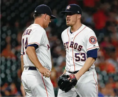  ?? Karen Warren / Houston Chronicle ?? Ken Giles, right, was in a foul mood when taken out of Tuesday’s game by Astros manager A.J. Hinch after giving up hits to all three batters he faced in the ninth inning. Giles’ next appearance will come at Class AAA Fresno after his demotion Wednesday.