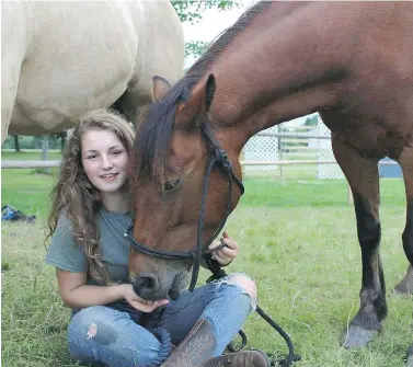  ?? COURTESY GERRIE DANGREMOND ?? Valerie Dangremond with horses Misty and Reiner. The family, who are Dutch immigrants to New Brunswick, have been told they could not keep the horses on their property, which is zoned as residentia­l.