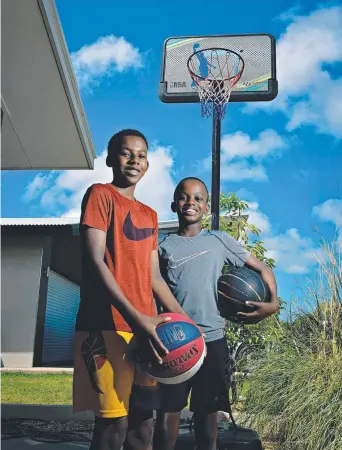  ?? Picture: MICHAEL FRANCHI ?? Zunga Siakalima, 14, and Wana Siakalima, 11, were the lucky recipients of basketball gear after their neighbours saw their love of the game