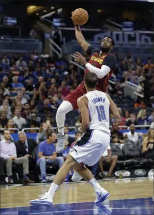  ??  ?? ASSOCIATED PRESS Cleveland Cavaliers’ Dwyane Wade, rear, makes a shot over Orlando Magic’s Evan Fournier during the first half of a preseason game in Orlando, Fla.