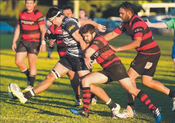  ?? PRESSURE: Mat Fanning of Brothers gets a kick away in Brothers hard fought TDRU win over the Ross River Redskins. Picture: SCOTT RADFORD- CHISHOLM ??