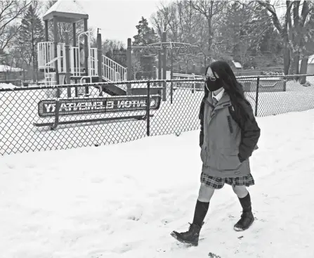  ??  ?? Fifth grader Reb Hardwick, 11, walks to Clinton Elementary School. The school is just a block from his home in Clintonvil­le.