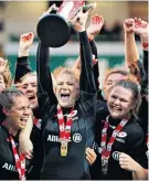  ??  ?? Winner: Saracens’ captain Lotte Clapp lifts the Premier 15s trophy last season