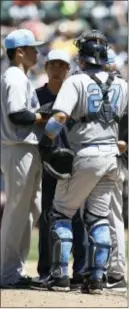  ?? THE ASSOCIATED PRESS ?? Yankees pitcher Masahiro Tanaka, left, meets with catcher Austin Romine, right, on the mound during the fourth inning.