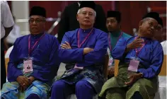  ?? (Reuters) ?? PRIME MINISTER Najib Razak (center) waits to submit his nomination papers for reelection yesterday in Pekan, Pahang, Malaysia.