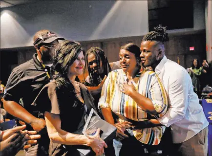  ?? Rachel Aston Las Vegas Review-journal @rookie__rae ?? Bryan Lagrange hugs his mom, Tyria Smith, as she reacts to the news that she will receive a new car, next to counselor Dana Papania, left, and her other children Donovan Reed, far left, and Loren Sampey at Sierra Vista High School’s senior award ceremony Thursday.