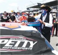  ?? AP PHOTO/JOHN BAZEMORE ?? Driver Bubba Wallace, left, is overcome with emotion as team owner Richard Petty comforts him as he arrives at his car in the pits of the Talladega Superspeed­way on Monday.