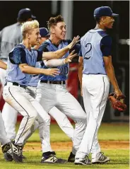  ?? Michael Wyke / Contributo­r ?? Reliever Nick Luckett, right, is swarmed by teammates after striking out Lamar’s Jacob Swerdloff to close out the 8-3 victory.