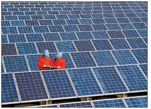  ?? AP ?? Workers check solar panels at a solar power station on a factory roof in Changxing in eastern China’s Zhejiang province in this 2012 photo.