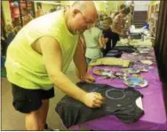  ?? EVAN BRANDT — DIGITAL FIRST MEDIA ?? Michael Heffner of Boyertown was one of hundreds of people who descended on the Pottstown Regional Public Library Friday to make a Galaxy shirt and get a free pair of eclipse glasses.