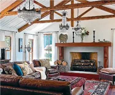  ??  ?? The open-plan living area of Ross and Jacqui Crowe’s Kapiti Coast house features a mix of 19th-century French crystal chandelier­s along the length of the room.