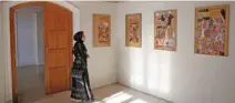  ?? - Reuters ?? ENGROSSED: An Afghan woman looks at art exhibition at Babur Garden in Kabul, Afghanista­n on March 31, 2018.