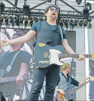  ?? MITCH MACDONALD/THE GUARDIAN ?? Kristian Bush yells to the crowd from the Lotto Max Main Stage of the Cavendish Beach Music Festival during his performanc­e Saturday afternoon. Bush is well-known as one half of the country music duo Sugarland.