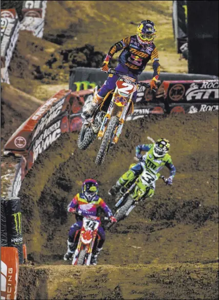  ?? L.E. Baskow Las Vegas Review-Journal @Left_Eye_Images ?? Cooper Webb (2) takes a big jump during the 450SX main event Saturday at Sam Boyd Stadium. He finished third and clinched the AMA Supercross title.