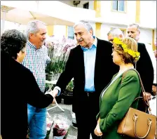 ??  ?? President Mustafa Akıncı and first lady Meral Akıncı greeted by Tatlısu villagers