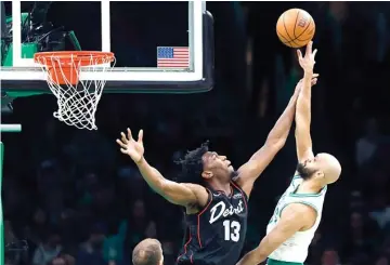  ?? ?? Boston Celtics’ Derrick White, right, shoots against Detroit Pistons’ James Wiseman (13) on Monday during an NBA basketball game in Boston. (AP photo/michael Dwyer)