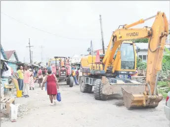  ??  ?? Trucks and excavators were brought on site yesterday to aid in the removal of materials in preparatio­n for road repairs.