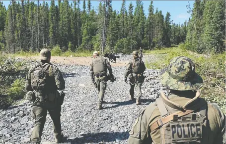 ?? MANITOBA RCMP/HANDOUT VIA REUTERS ?? RCMP officers search near Gillam, Manitoba, for Kam Mcleod and Bryer Schmegelsk­y on July 29. Their bodies were found in the area Aug. 7, along with a digital camera that contained video clips in which they admitted their roles in the deaths of three people.