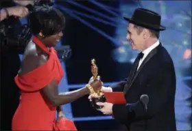  ?? THE ASSOCIATED PRESS ?? Mark Rylance, right, presents Viola Davis with the award for best actress in a supporting role for “Fences” at the Oscars on Sunday, Feb. 26, at the Dolby Theatre in Los Angeles.