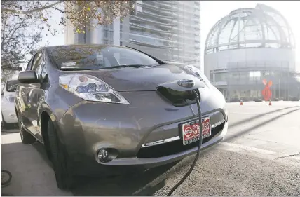  ?? GARY REYES — STAFF ARCHIVES ?? A car is plugged in at an electric vehicle charging station near City Hall in San Jose. Assemblyma­n Phil Ting, D-Richmond, is pushing a proposal to establish a $3billion fund to support the spread of electric vehicles.