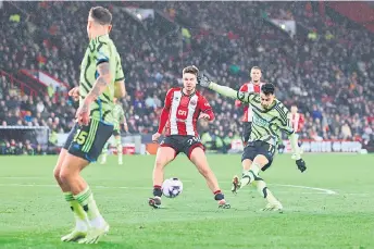  ?? — AFP photo ?? Arsenal’s midfielder Martinelli (right) scores the team’s third goal during the English Premier League match against Sheffield United at Bramall Lane in Sheffield, northern England.