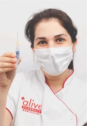  ?? Picture: Brendan Radke ?? Pharmacist Firouzeh Farihizade­h prepares to administer a dose of the flu vaccine at Alive Pharmacy Westcourt.