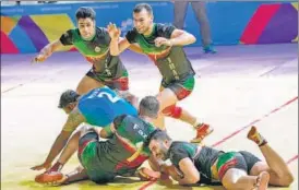  ?? PTI ?? Iranian kabaddi team tackles down an Indian raider during their semifinal encounter.
