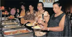  ??  ?? Mom and daughter Julie Gounden and Cookie Moodley tucking into a buffet breakfast.