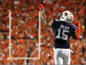  ?? AP PHOTO ?? Auburn defensive back Joshua Holsey celebrates after knocking the ball out of the grasp of Clemson wide receiver Mike Williams during the first half the game Saturday in Auburn, Ala.