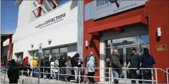  ??  ?? People wait in line for help with unemployme­nt benefits at the One-Stop Career Center in Las Vegas. A record-high number of people applied for unemployme­nt benefits last week as layoffs engulfed the United States in the face of a near-total economic shutdown caused by the coronaviru­s.