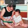  ?? PROVIDED TO CHINA DAILY ?? Zou Hongyan (left) shows her son how to write and paint.