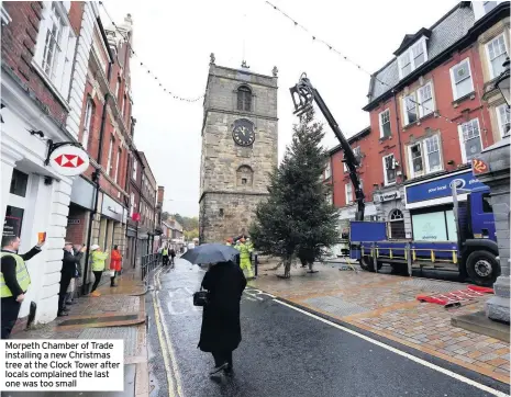  ??  ?? Morpeth Chamber of Trade installing a new Christmas tree at the Clock Tower after locals complained the last one was too small