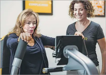  ?? Diane Feil ?? LISA THOMAS works to boost her bone density using the upper growth trigger machine at OsteoStron­g, which is expanding fast.