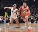  ?? AP ?? Texas’ Madison Booker drives past UCF’s Kaitlin Peterson during the second half of the Longhorns’ 87-56 victory Saturday. Booker scored 22 points and had five assists.