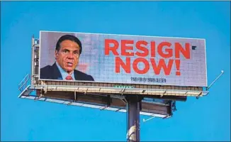  ?? Matthew Cavanaugh Getty Images ?? NEW YORK Gov. Andrew Cuomo is under pressure — as this billboard photograph­ed Tuesday in Albany shows — after three women came forward to accuse him of unwanted advances.